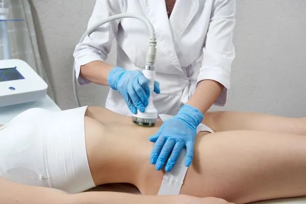 Lost the Weight but Not the Loose Skin? 2 woman having HIFU treatment on her stomach to combat loose skin Devizes following weight loss